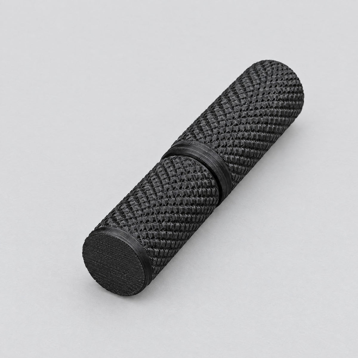 Black Root Pass tungsten electrode case with a textured grip and plain black base.