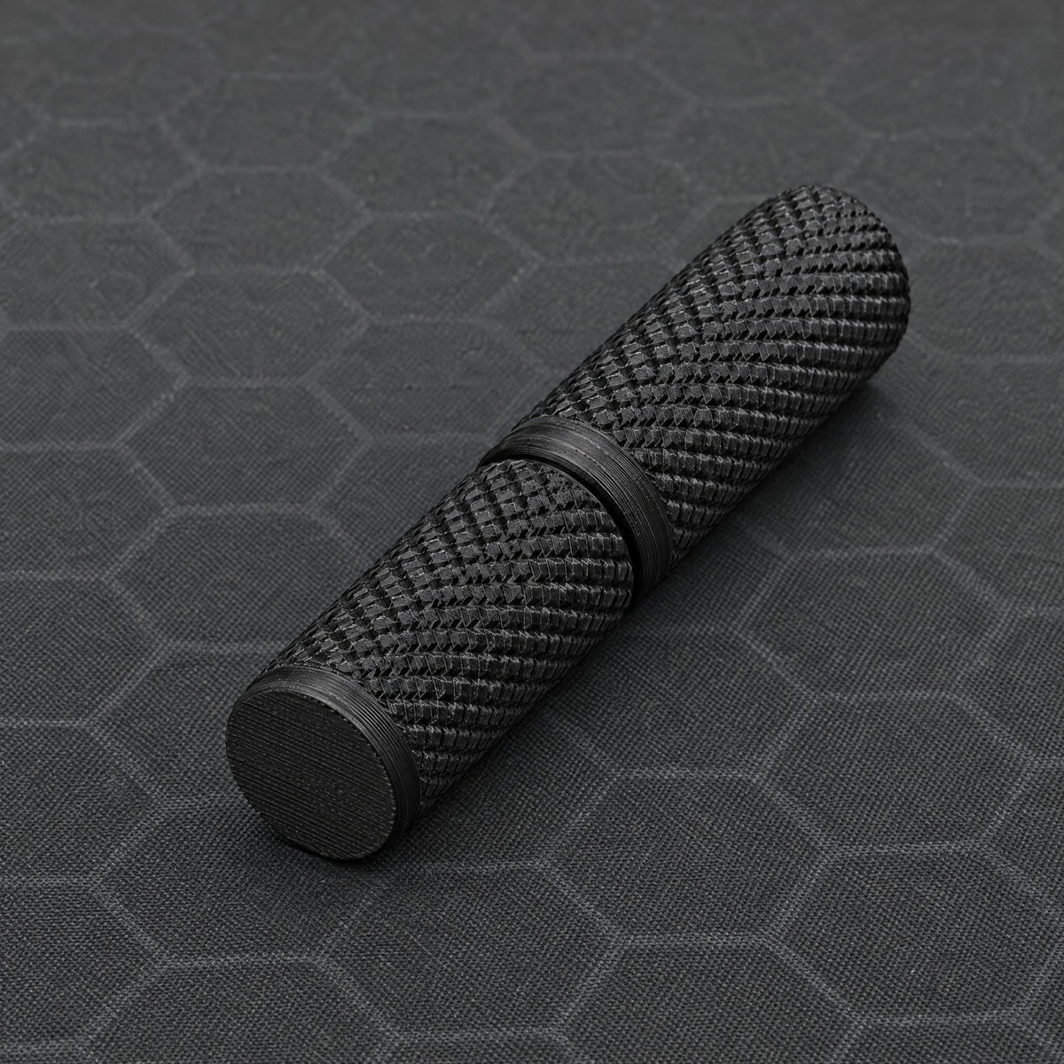 Closed black tungsten electrode case showing its textured surface.